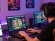 Player engaged in online gaming with link alternatif raja328 visible on smartphone, showcasing vibrant casino atmosphere.