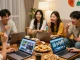 Friends discussing favorite Asian shows at https://hanadultalk.com with snacks and laptops in a cozy living room.