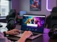NAGA2000 DAFTAR login interface displayed on a laptop in a vibrant gaming lounge.